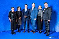 Impressionen von der Begrüßung der Gäste – Portraitaufnahmen vor einer blauen Fotowand