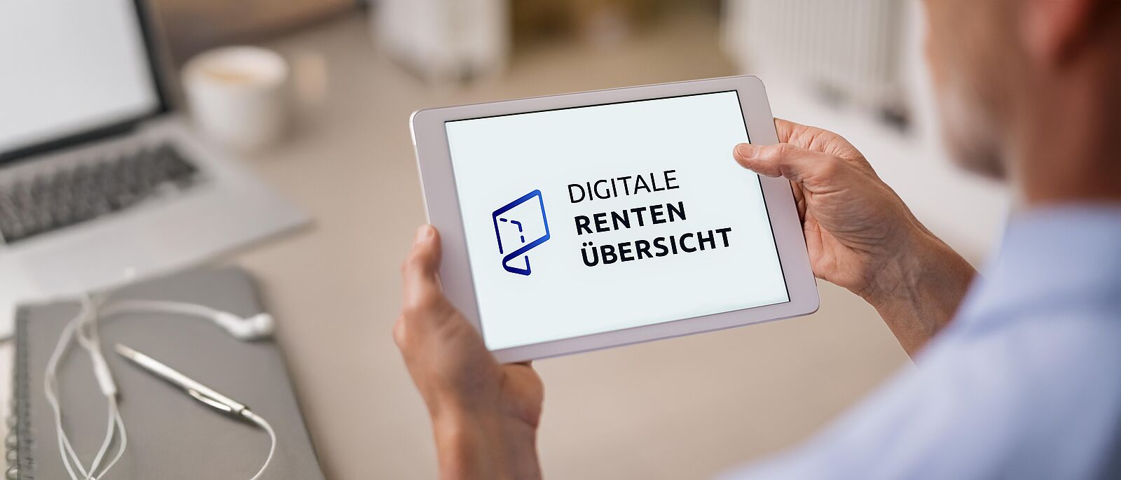 Makroaufnahme von einer Person, die ein weißes Tablet in der Hand hält. Auf dem Tablet ist das Logo der Digitale Rentenübersicht zu sehen